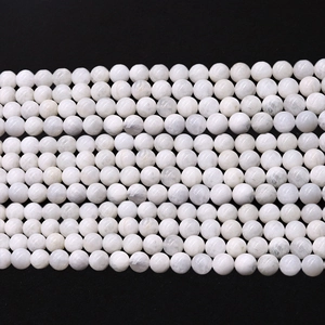 Polished natural moonstone beads for DIY jewelry making neatly arranged on black background