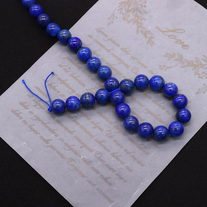 Detailed macro shot of natural lapis lazuli round beads with deep blue texture
