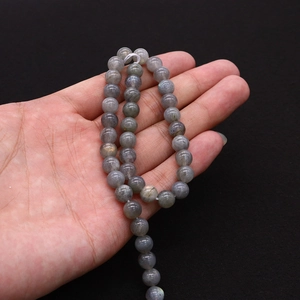 Detailed view of natural labradorite round beads showing characteristic labradorescence sheen