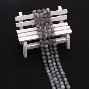 Detailed view of polished natural labradorite beads showing blue-green iridescent flash