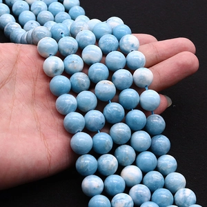 Natural Larimar blue stone round beads strand held in hand for DIY necklace making
