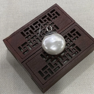 32mm flat round shell pendant with sparkling diamond bail on a vintage wooden gift box