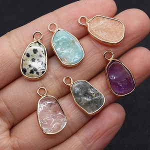 Close-up of six teardrop-shaped natural stone pendants with gold-plated metal edges