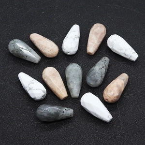 Close-up of teardrop faceted natural stones including white turquoise and labradorite beads