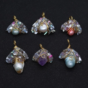 Handcrafted pearl and resin pendants with gold wire wrapping in irregular mushroom shapes