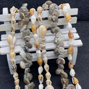 Natural sea shell beads 8-12mm set for DIY jewelry making on a mini white bench