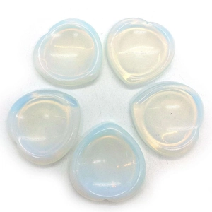 Five heart-shaped opalite thumb stones with soft translucent milky blue glow and smooth finish