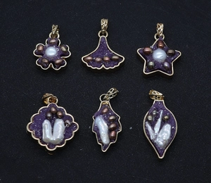 Macro detail of six purple geode flower pendants with gold plating and pearl insets