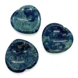 Set of three heart-shaped Kambaba Jasper massage stones with green ring patterns