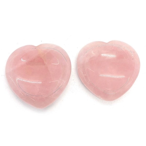 Polished heart-shaped rose quartz massage stones with natural crystal textures