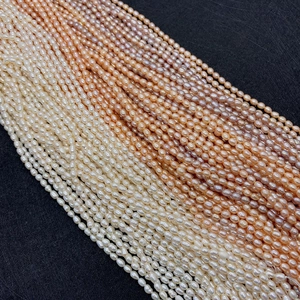 Macro detail of natural rice-shaped freshwater pearls in purple, pink, and white tones