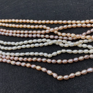 Macro detail of natural freshwater rice pearls in white, pink, and purple colors