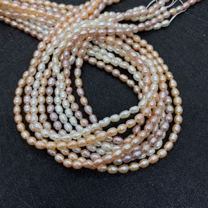 Macro detail of natural freshwater rice pearls in purple pink and white strands