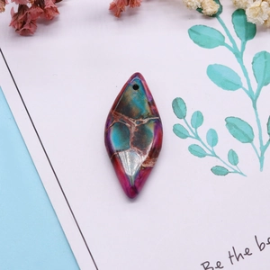 Natural turquoise marquise pendant with vibrant blue and purple stone patterns