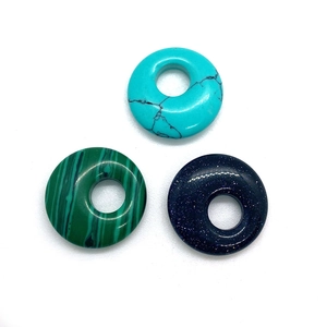 Three natural stone donut pendants in turquoise, malachite, and blue sandstone finishes