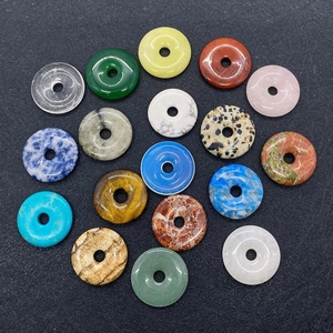 Macro view of assorted 25mm gemstone pi discs including tiger eye and lapis lazuli