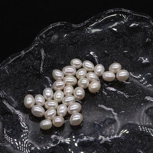 Natural freshwater rice-shaped pearls on a crackle glass tray for DIY jewelry making
