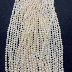 Macro shot of AAA natural freshwater white pearls strands for jewelry DIY crafting