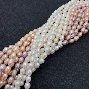 Close-up of high-luster natural freshwater rice pearls in white, pink, and purple colors