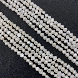 Macro shot of natural baroque freshwater pearls showing rich luster on a black background