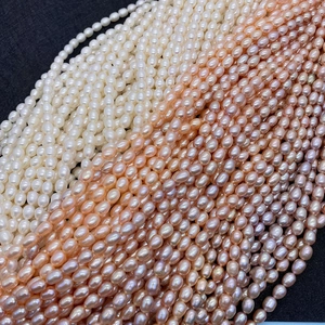 Macro shot of high luster AAA grade oval freshwater pearls in white, pink, and purple