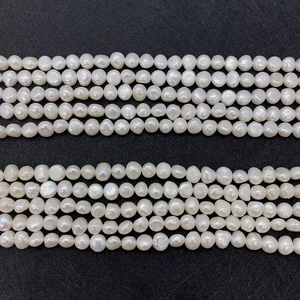 Macro view of natural white freshwater pearls showing baroque shapes and iridescent luster