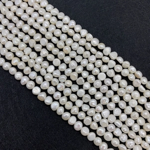 Macro view of irregular Baroque freshwater pearls with strong luster on black background