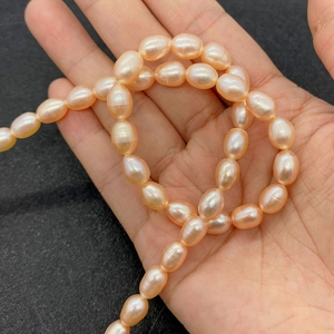 Macro detail of natural pink rice-shaped freshwater pearls with a high luster finish