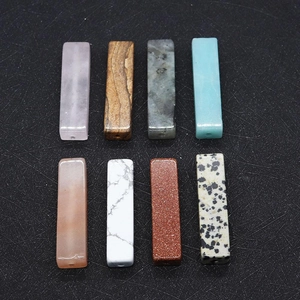 Detail view of rectangular natural stone beads showing pre-drilled holes for DIY jewelry