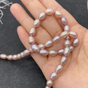 Macro view of AAA grade lavender oval rice-shaped freshwater pearls with high luster