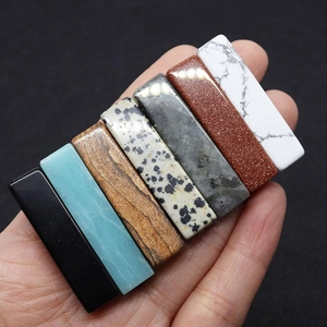 Polished rectangular natural stone beads set including jasper and quartz held in hand