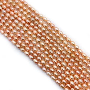 Strands of natural pink-orange rice-shaped freshwater pearls for DIY jewelry making