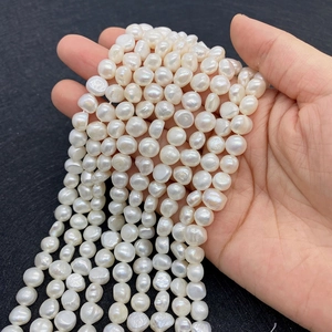 Natural white freshwater baroque pearls held in hand for DIY jewelry making