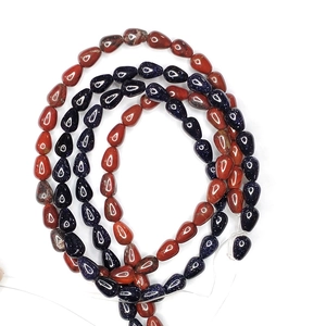 Detailed macro view of teardrop natural blue goldstone and red agate beads for jewelry DIY