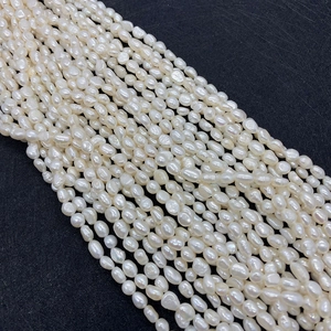 Détail de plusieurs rangs de perles d'eau douce naturelles blanches de forme baroque