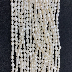 Vue détaillée de perles d'eau douce blanches brillantes pour la création de bijoux