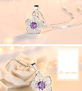 Detailed view of silver cherry blossom pendant with purple gemstone and elegant box chain