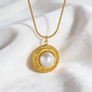 Vintage gold snake chain necklace with round pearl pendant and embossed metal textures