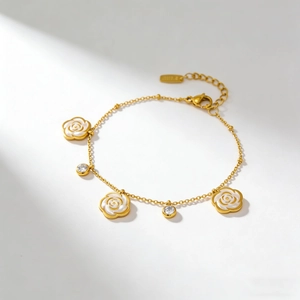 Elegant gold chain bracelet featuring three white camellia pendants and sparkling zircons