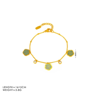 Detailed view of an 18K gold-plated camellia bracelet with green enamel and zircons