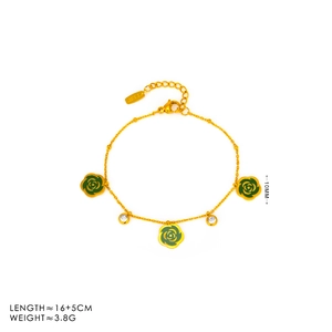 Detailed macro view of gold bracelet with green camellia charms and zirconia accents