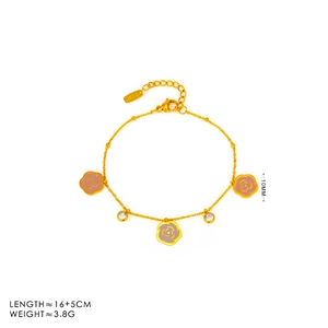 Detail of a gold-tone bracelet with pink enamel camellias and clear zircon charms