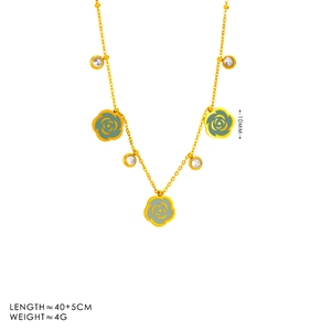 Detail of gold necklace with pale green camellia charms and clear zircon stones