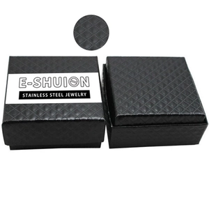 Caja de regalo negra cuadrada para joyas con textura acolchada y logo en fondo blanco