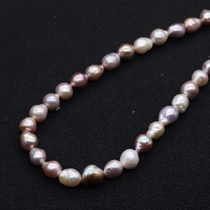 Baroque natural freshwater pearl necklace with multi-color metallic luster on black background
