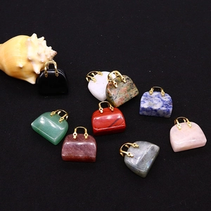 Macro detail of various natural gemstone handbag charms with golden metal handles