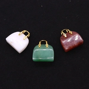 Three natural stone handbag pendants in white green and red brown with golden metal handles