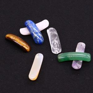 Close-up of assorted natural semi-precious stone curved tube beads for DIY jewelry making