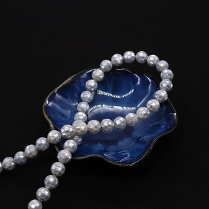 Vue macro de perles mosaïques en nacre d'abalone facettées avec éclat irisé