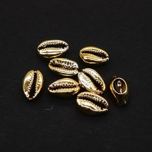 Detailed view of gold plated conch shell beads for DIY jewelry and accessory making